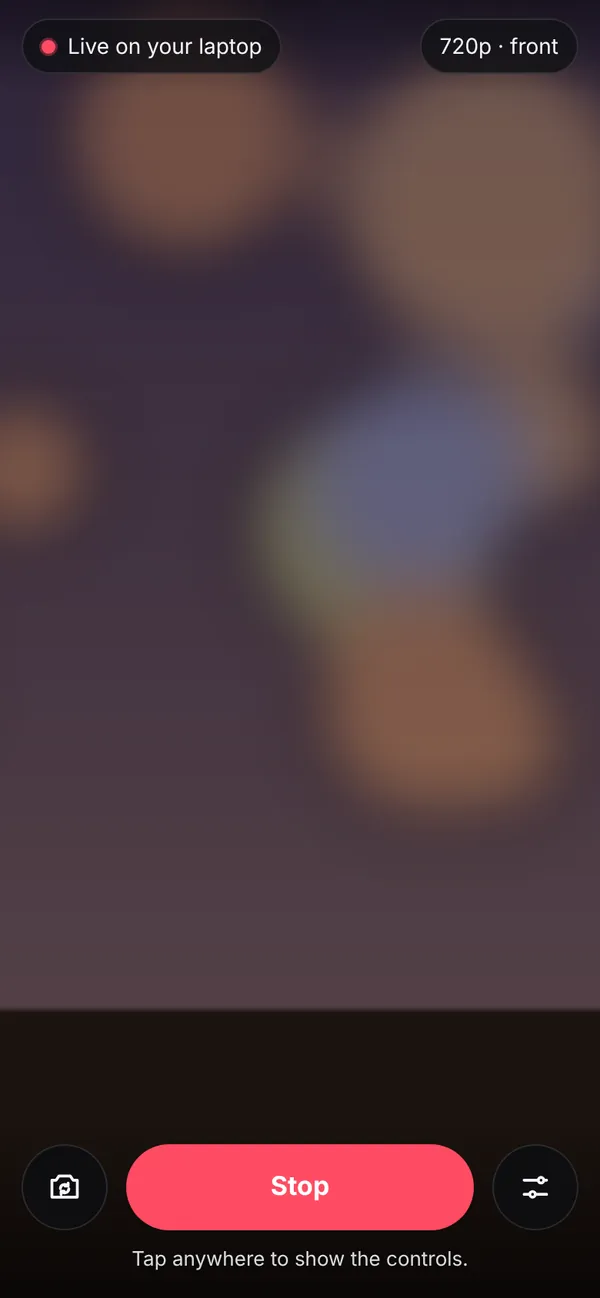 The phone while live with its controls showing: a camera flip button, a red Stop button and a settings button